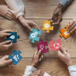 hands holding puzzle pieces with different symbols on them